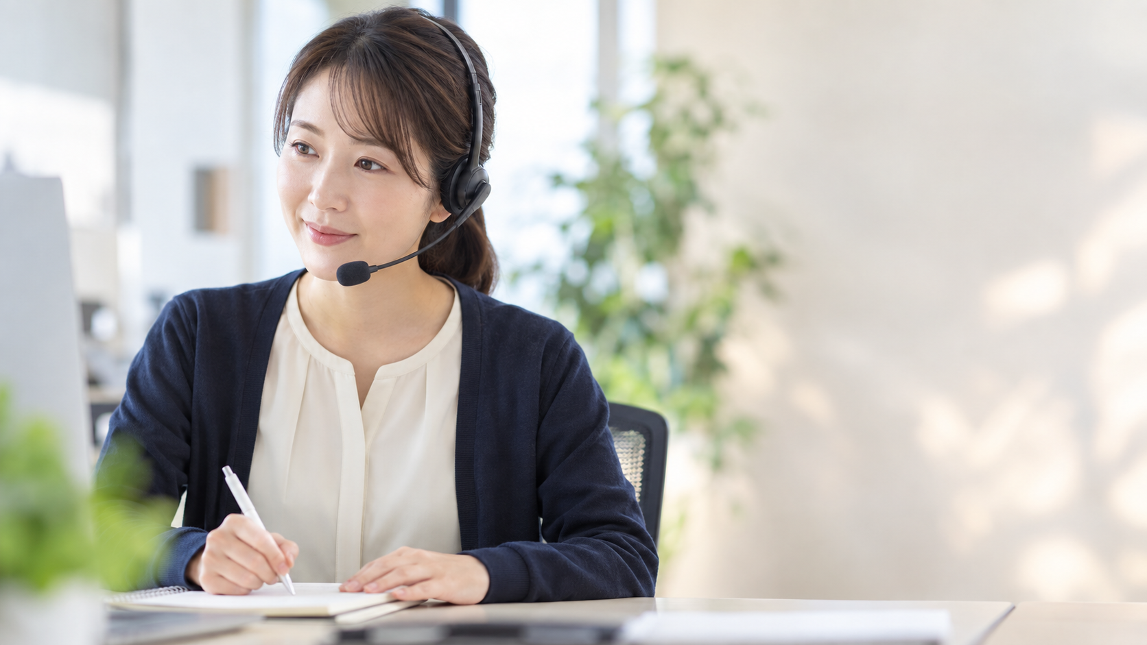 ヘッドセットを着けて相談に対応するスタッフ